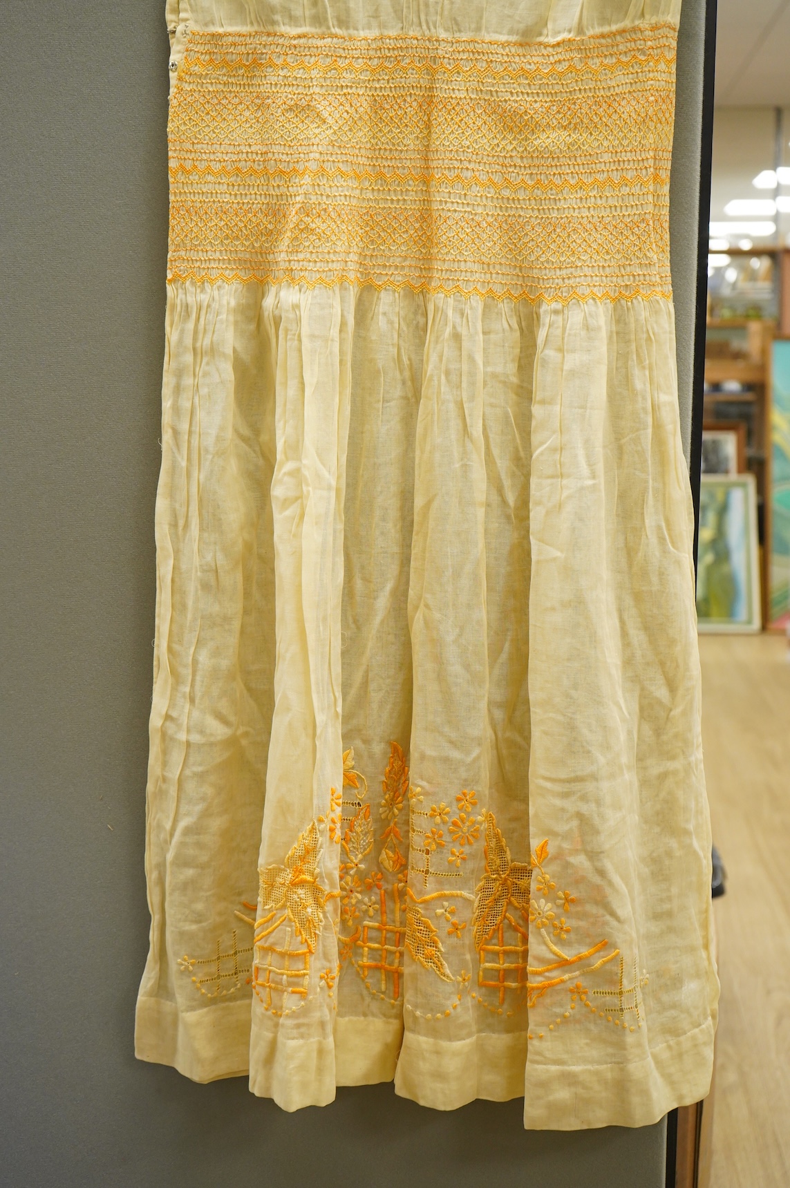 A 1920-30's fine yellow cotton gauze, embroidered and smocked day dress. 117cm long. Condition - good